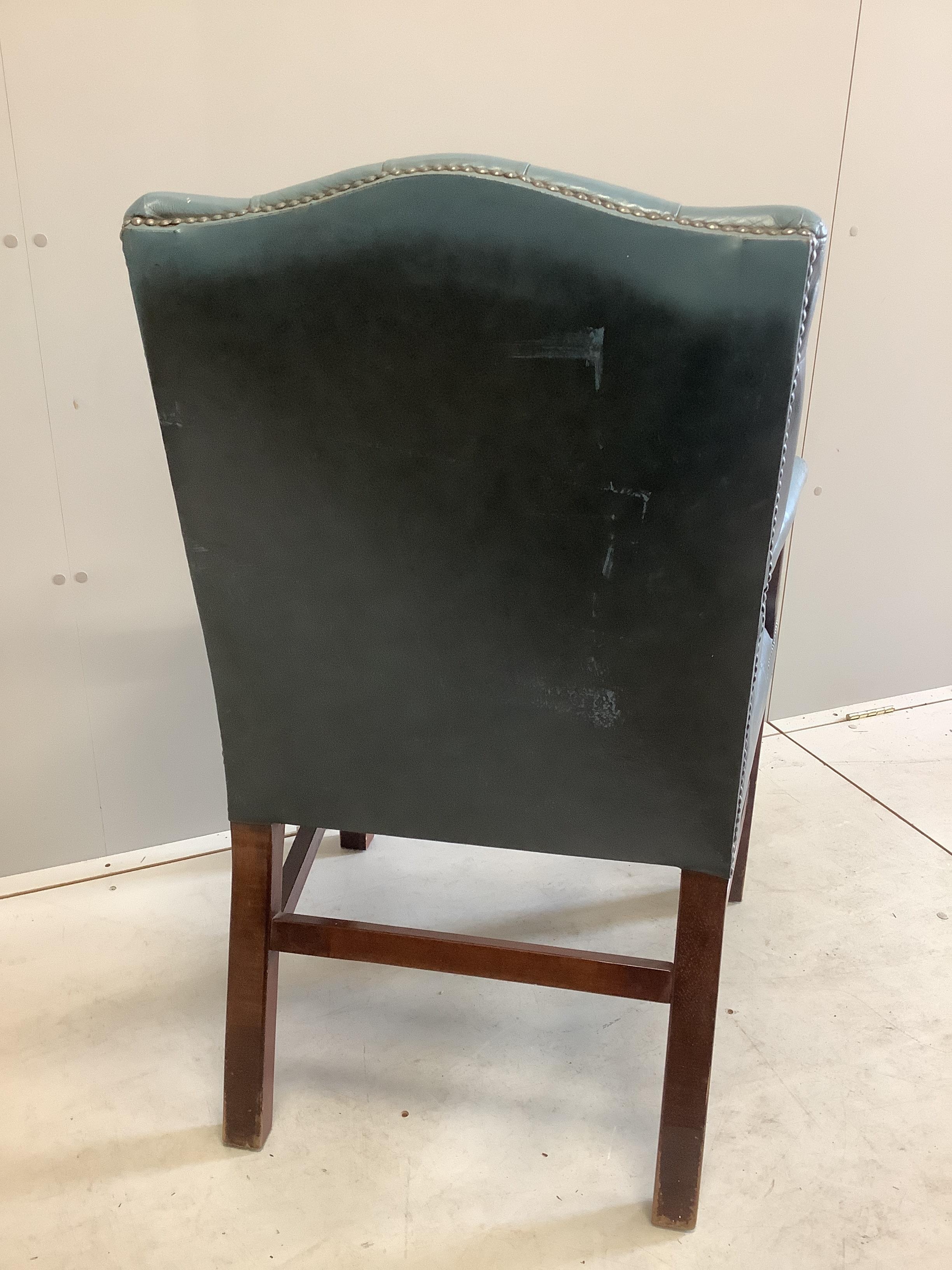 A reproduction Gainsborough style buttoned blue leather library chair, width 60cm, depth 54cm, height 99cm